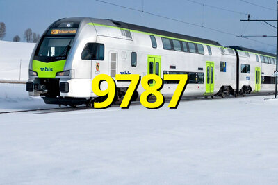 Zug der BLS in verschneiter Landschaft.