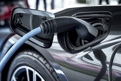 Ein an der Ladestation angeschlossenes Auto.